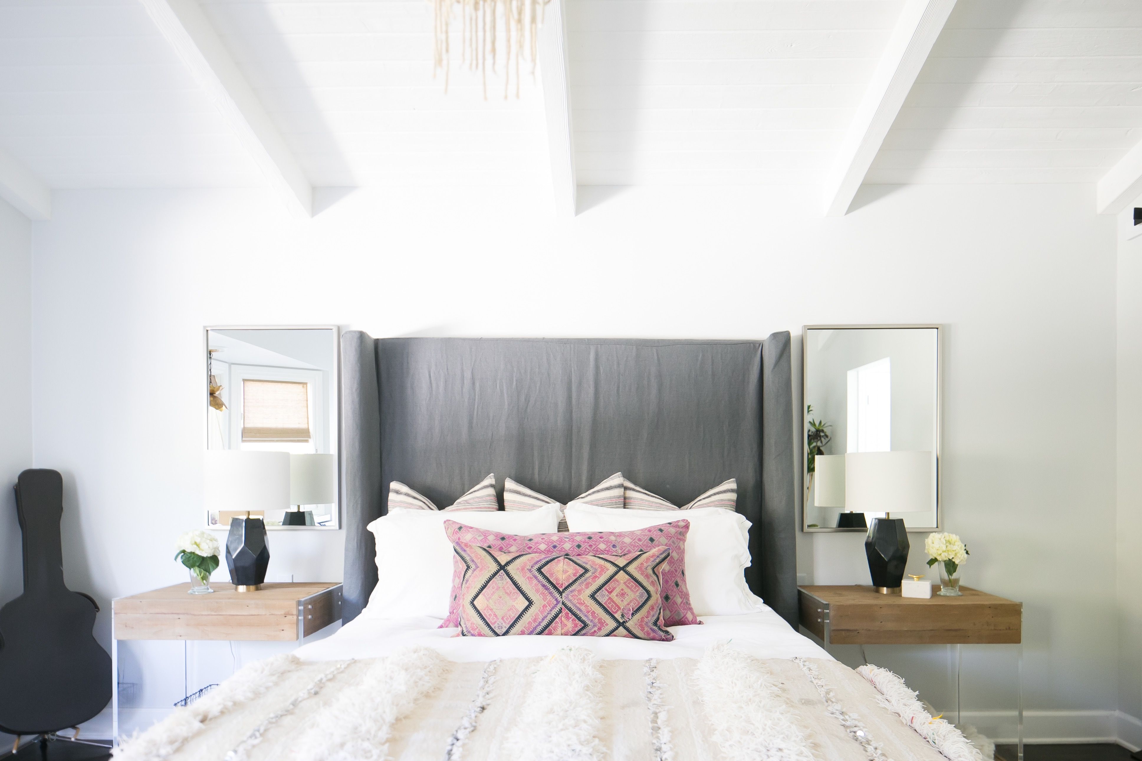 Modern Bedroom With Gray Upholstered Headboard And Black Geometric Table Lamps (View 17 of 23)