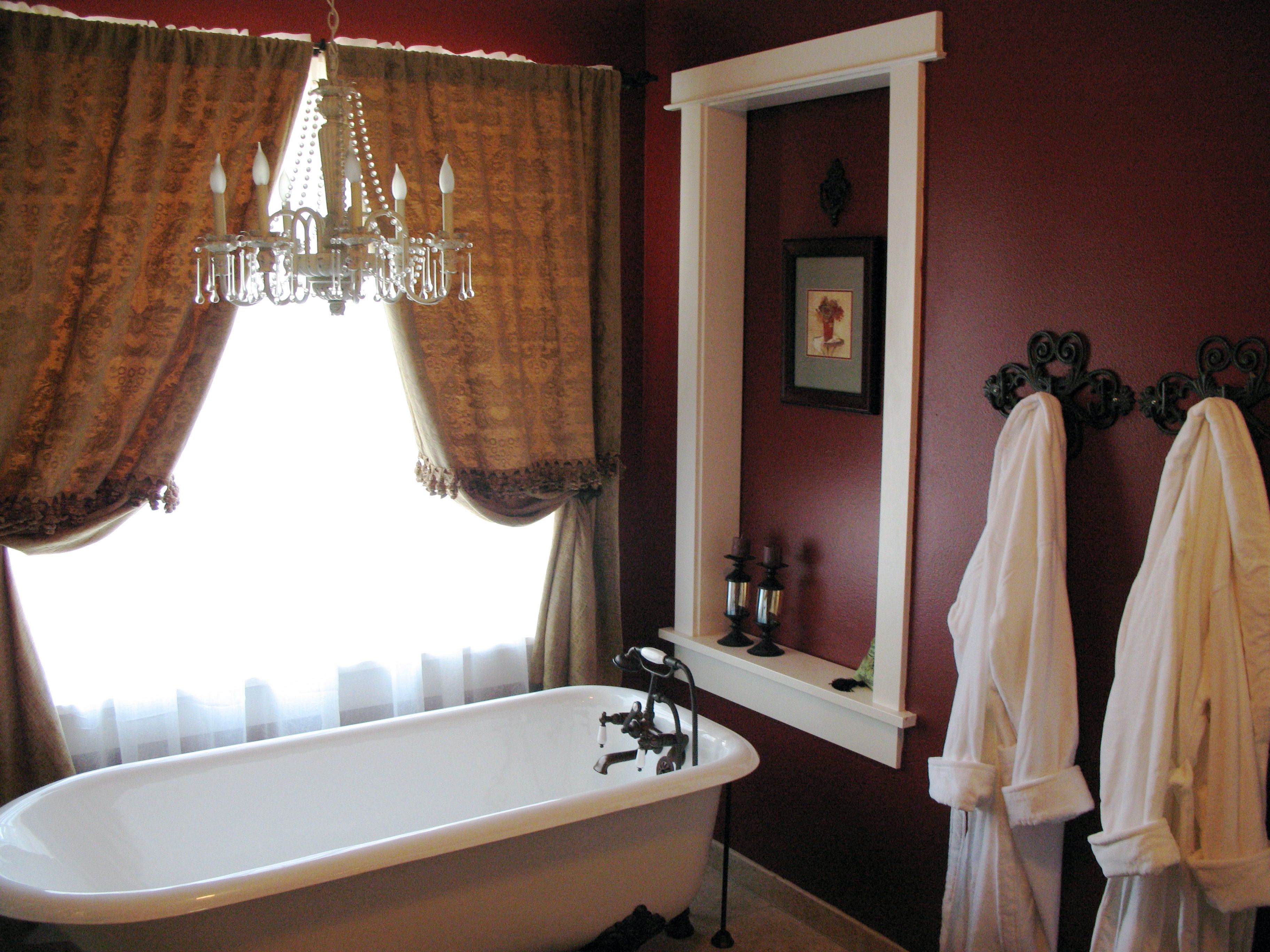 Classic Red Bathroom With A Claw Foot Tub And Chandelier Also Tied Back Curtains (View 11 of 29)