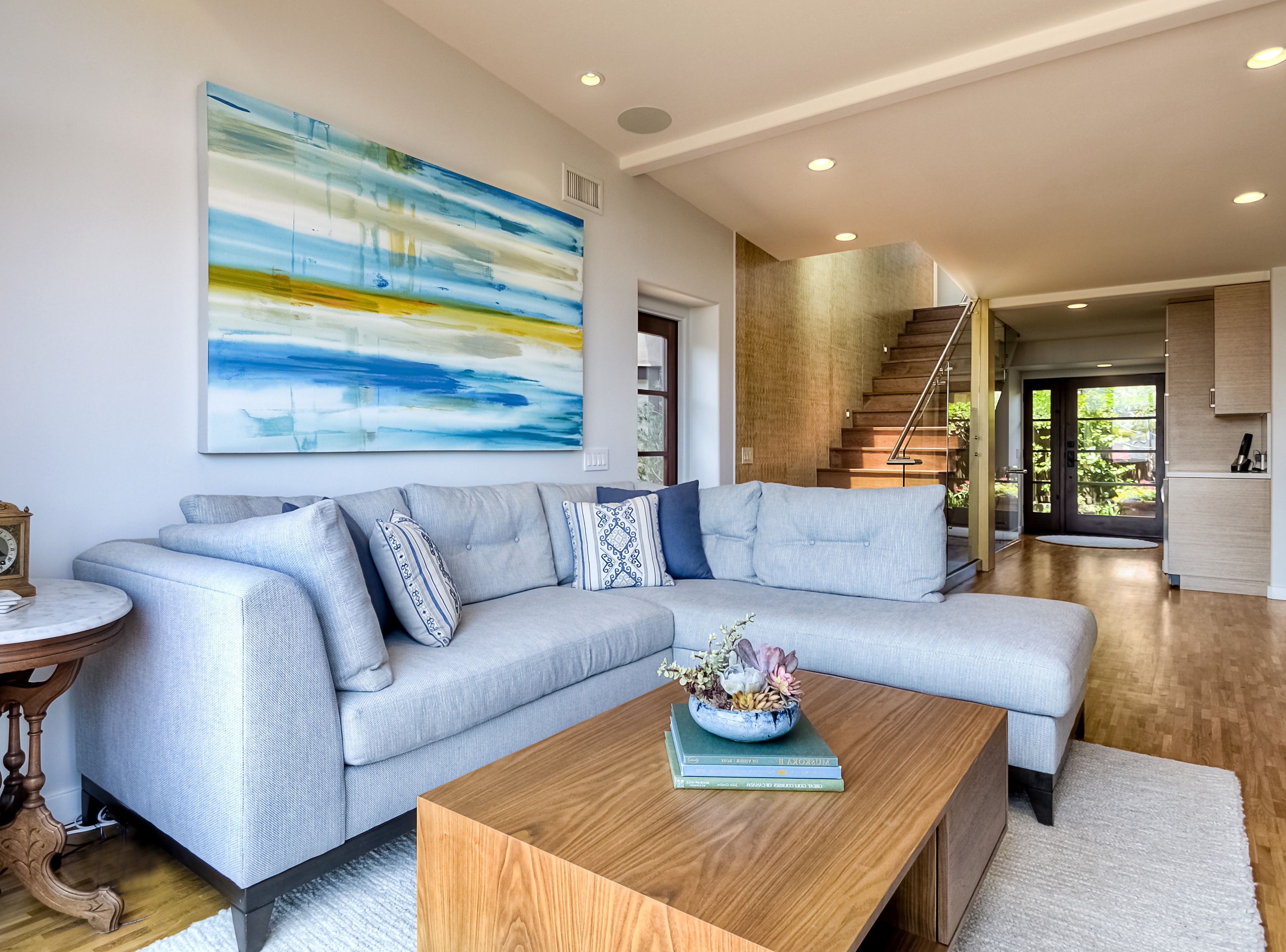 Warm And Cozy Modern Narrow Living Room Featuring Ice Blue Sectional Sofa And Modern Art (View 10 of 22)
