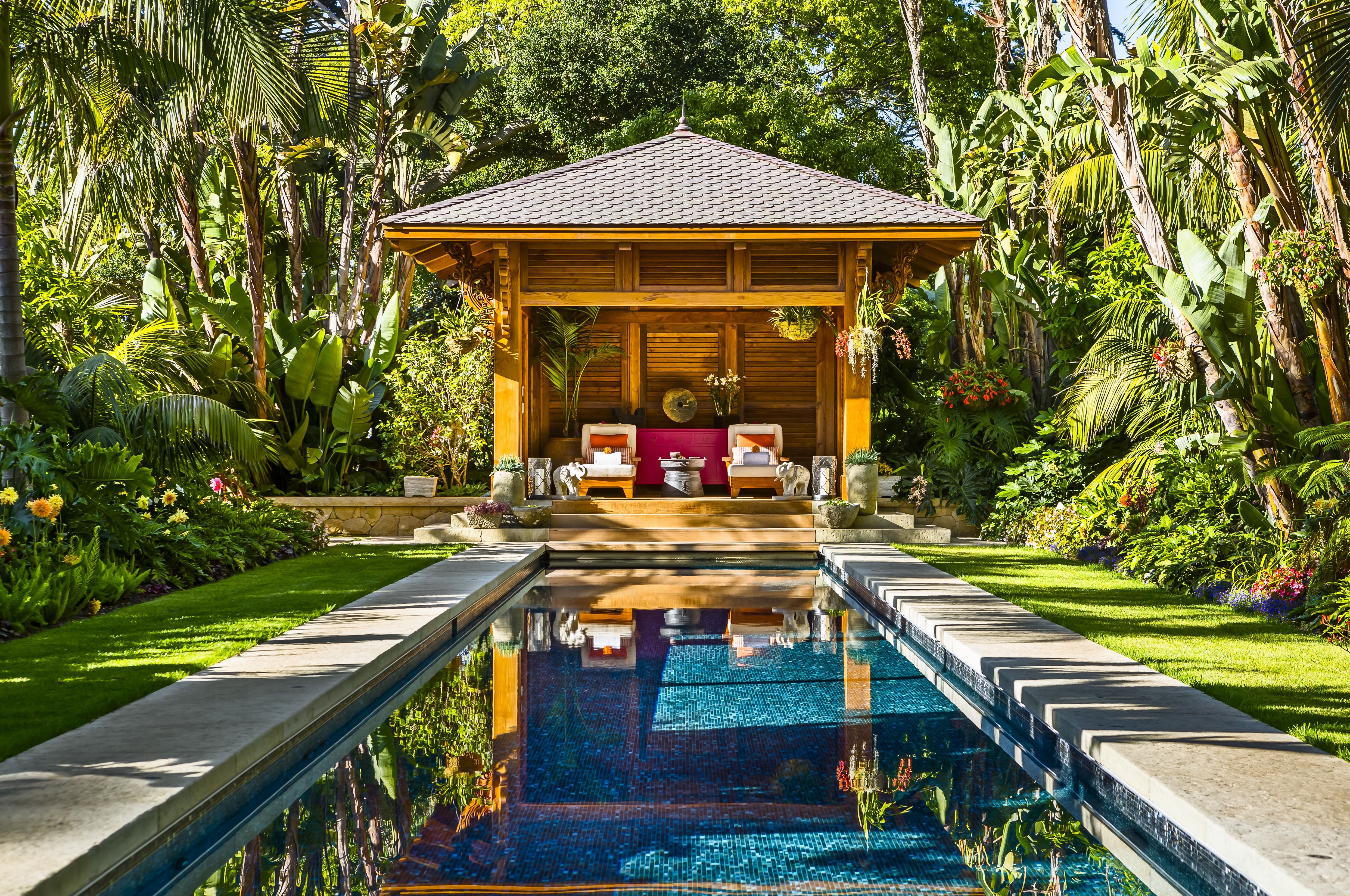 Beautiful Tropical Garden With Cushioned Seating And Lap Pool (View 5 of 30)