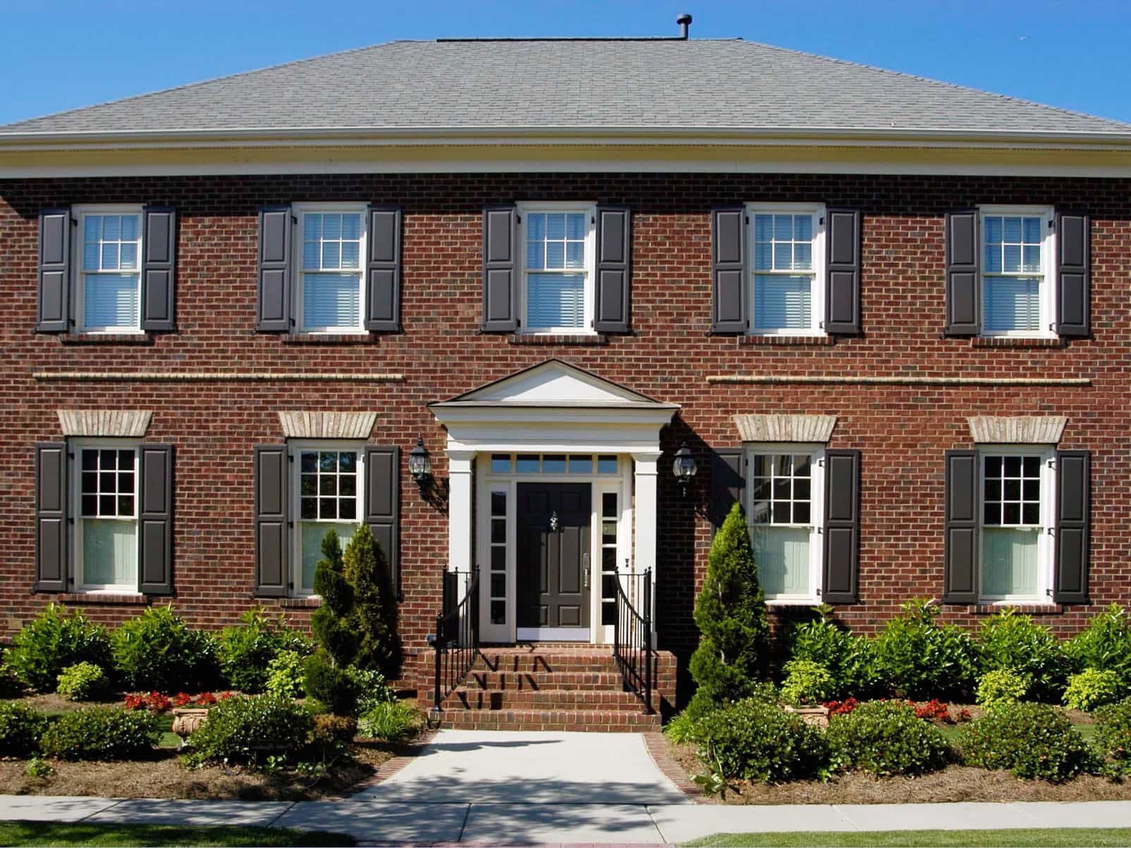 Featured Photo of Colonial Brick House Exterior With Black Shutters
