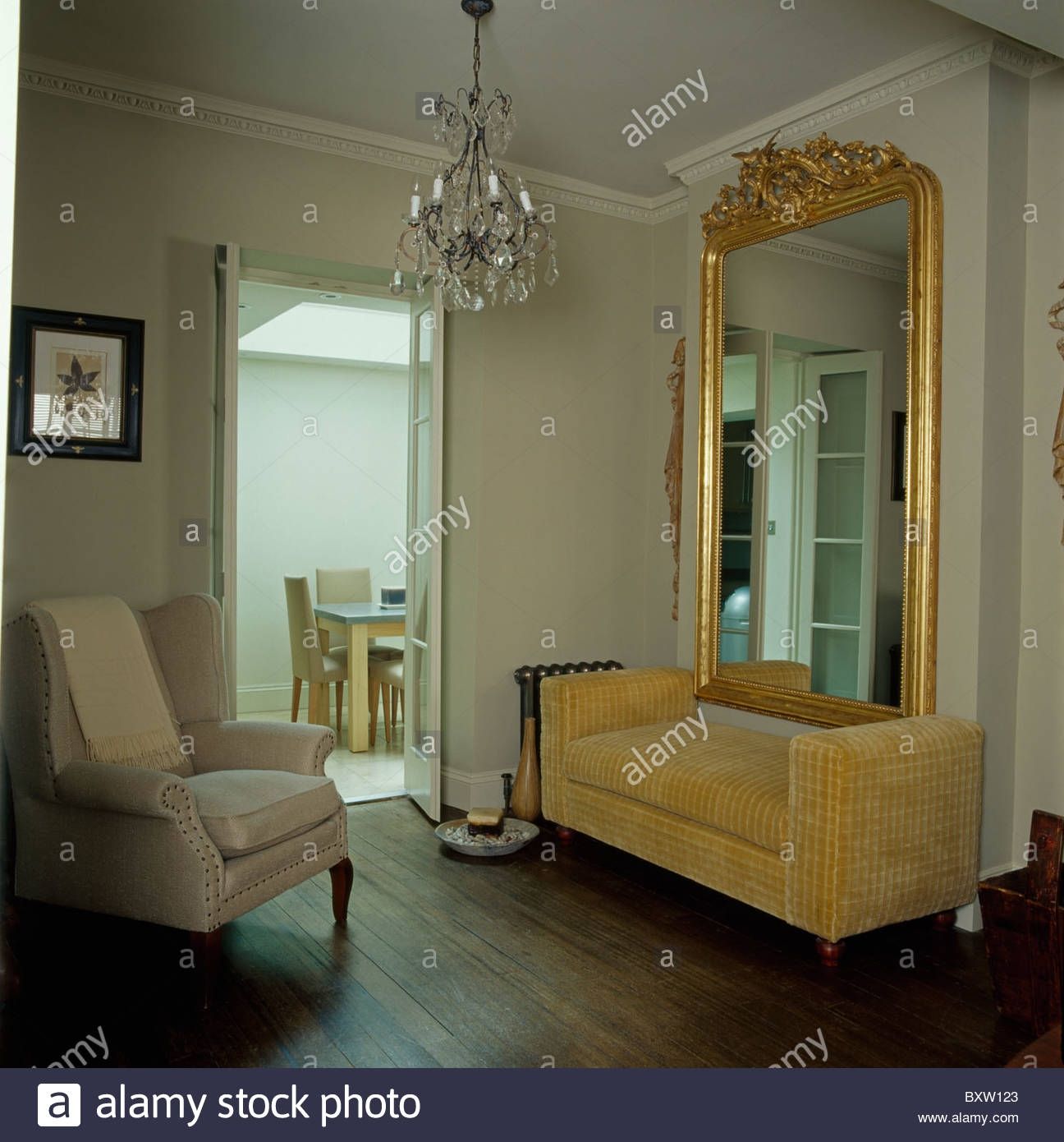 Large Ornate Antique Gilt Mirror Above Beige Velvet Sofa In Living With Ornate Large Mirror (View 7 of 15)