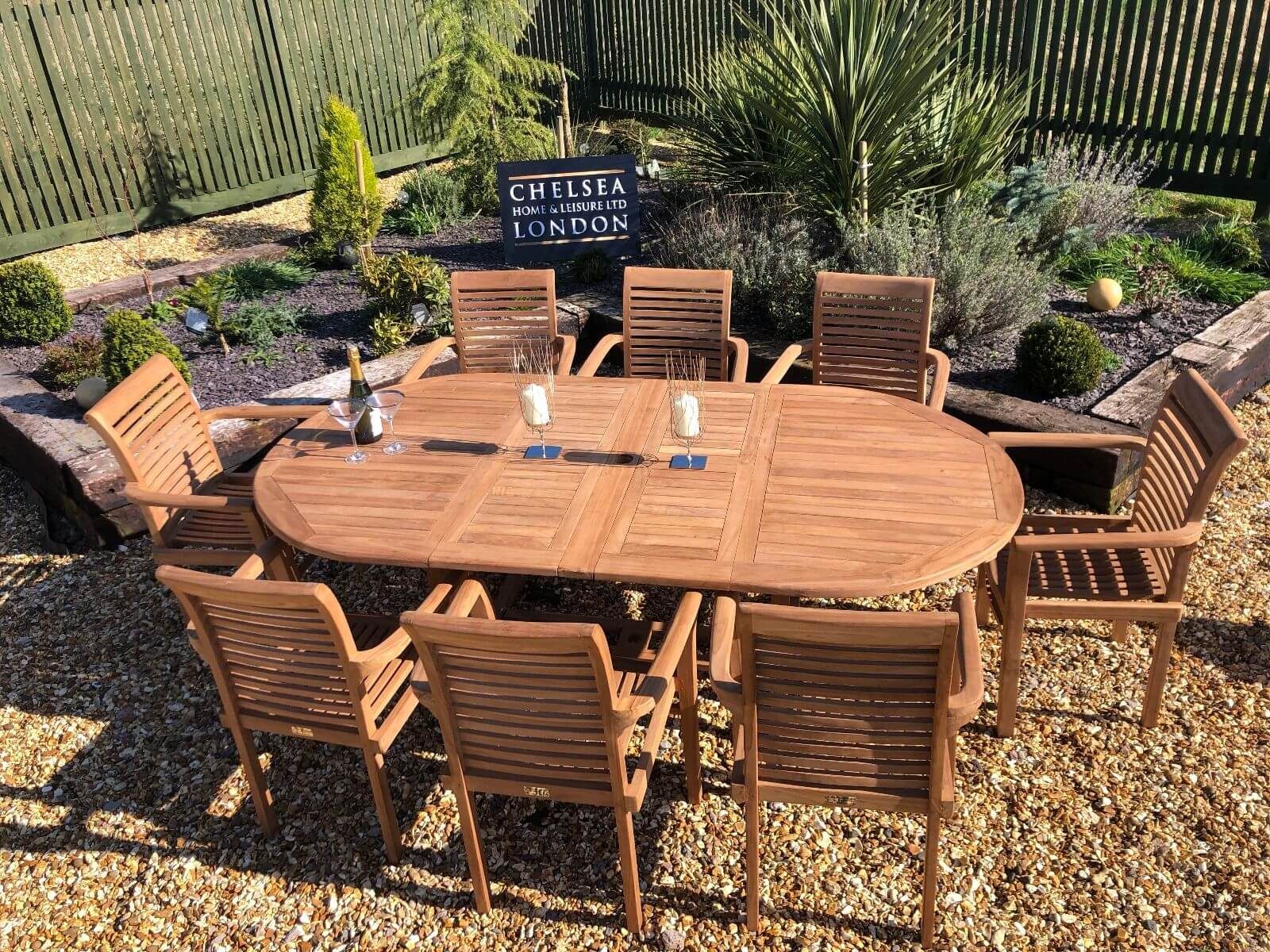 Luxury Extending Teak Table With 8 Stacking Teak Chairs – Chelsea Home Intended For Extendable Oval Patio Dining Sets (View 5 of 15)