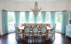 Coastal Dining Room With Aqua Decor and Ornate Chandelier
