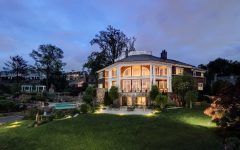 Colonial Waterfront Home With Stone Terrace and Large Tall Pillars