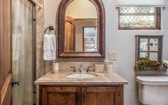 Granite Countertop for Cottage Bathroom With Single Vanity and Arched Mirror