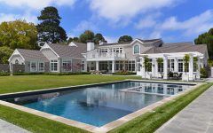 Gray Cape Cod With Manicured Backyard and Pool