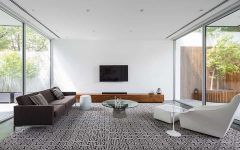 Large Minimalist Living Room With Carpet and a Wall Mounted Tv